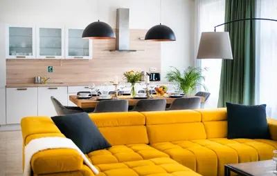 a living room with a yellow couch and a table at Centrum Apartments Pstrossova in Prague