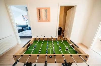 a football table in the middle of a living room at Centrum Apartments Pstrossova in Prague