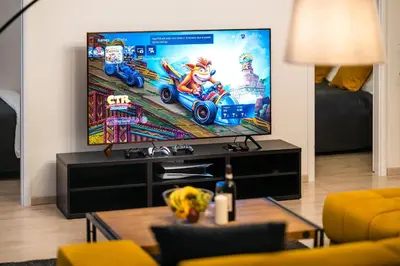 a living room with a tv with a video game on the screen at Centrum Apartments Pstrossova in Prague