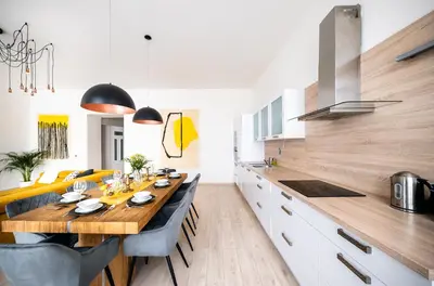 a kitchen with a long wooden table in a room at Centrum Apartments Pstrossova in Prague