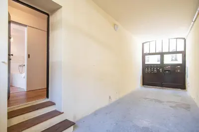 an empty hallway with a black door and stairs at Nice one bedroom apartment in zizkov in Prague
