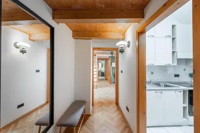 a kitchen with white cabinets and a wooden ceiling at Delux Romantic Stay Prague in Prague