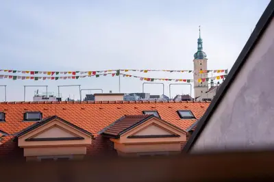 a view of roofs of a building with a clock tower at Delux Romantic Stay Prague in Prague