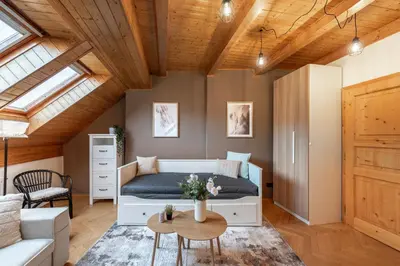 a bedroom with a bed and a couch and a table at Delux Romantic Stay Prague in Prague