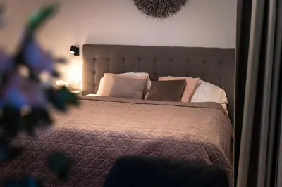 a bedroom with a large bed with pillows at Luxury Angel Apartment with terrace in Prague