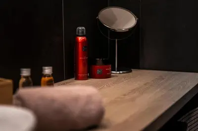 a table with a red fire extinguisher and a mirror at Luxury Angel Apartment with terrace in Prague
