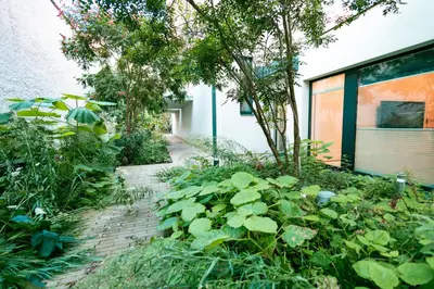 a garden in front of a building with plants at Luxury Angel Apartment with terrace in Prague