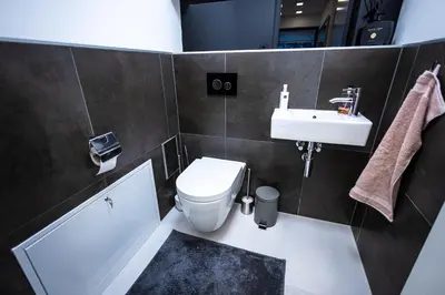a bathroom with a toilet and a sink at Luxury Angel Apartment with terrace in Prague
