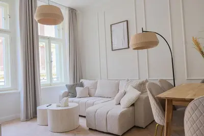 a white living room with a couch and a table at Rentero apartment, 4 minutes National Theather, Prague in Prague