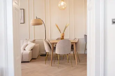 a dining room table with chairs and a lamp at Rentero apartment, 4 minutes National Theather, Prague in Prague