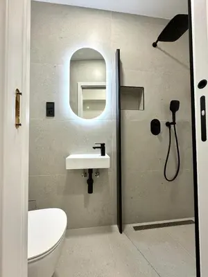 a bathroom with a shower with a sink and a toilet at Rentero apartment, 4 minutes National Theather, Prague in Prague