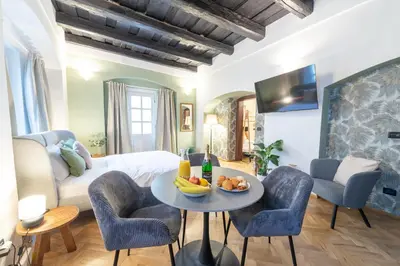 a bedroom with a bed and a table and chairs at Adam's Apartment - Great Price & Best Location in Prague