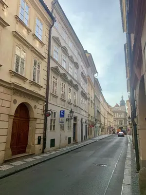 an empty city street with buildings and a car on the road at Adam's Apartment - Great Price & Best Location in Prague