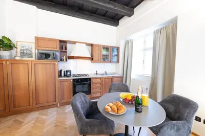 a kitchen with a table with a plate of food on it at Adam's Apartment - Great Price & Best Location in Prague