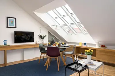a living room with a dining table and a skylight at Prague Days - One bedroom newly renovated apartment with workspace and Netflix in Prague