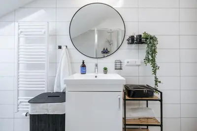a white bathroom with a sink and a mirror at Prague Days - Two-bedroom Apartment with Workspace and Netflix in Nusle in Prague