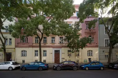 a group of cars parked in front of a building at Prague Days - Cozy Studio with Netflix in Karlín in Prague