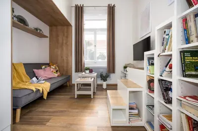 a living room with a couch and a table at Prague Days - Cozy Studio with Netflix in Karlín in Prague
