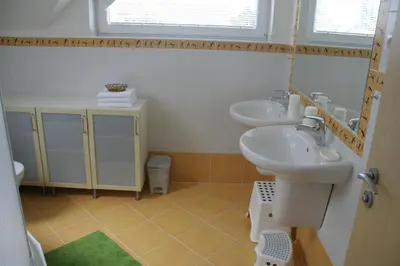 a bathroom with two sinks and a mirror at Holiday Home Prague Pruhonice in Pruhonice