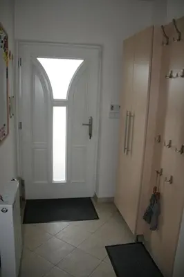 a hallway with a white door with a window at Holiday Home Prague Pruhonice in Pruhonice