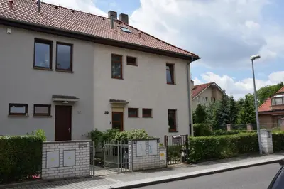 a white house with a fence in front of it at Classical House in Prague 6 in Prague