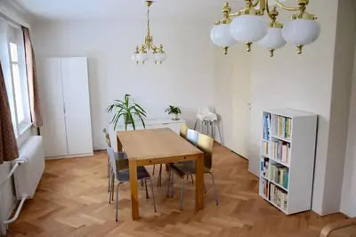 a dining room with a wooden table and chairs at Classical House in Prague 6 in Prague