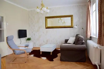 a living room with a couch and a chair at Classical House in Prague 6 in Prague