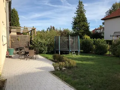 a patio with a table and chairs in a yard at Classical House in Prague 6 in Prague