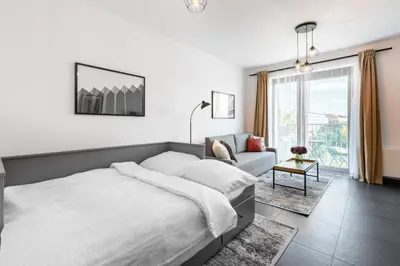 a bedroom with a bed and a couch at All-in Family Apartment Prague in Prague