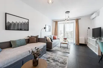 a living room with a couch and a table at All-in Family Apartment Prague in Prague