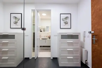 a bathroom with white cabinets and a sink at All-in Family Apartment Prague in Prague