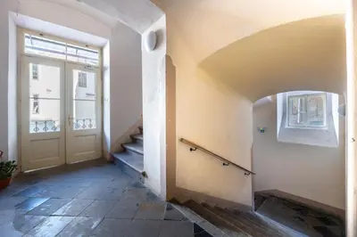 a hallway with a door and stairs in a building at King's Royal Apartments in City Centre in Prague