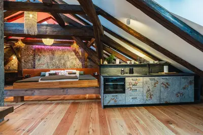 a bedroom with a bed and a wooden floor at King's Royal Apartments in City Centre in Prague