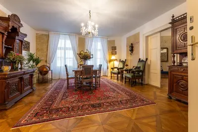 a living room with a table and a dining room at King's Royal Apartments in City Centre in Prague