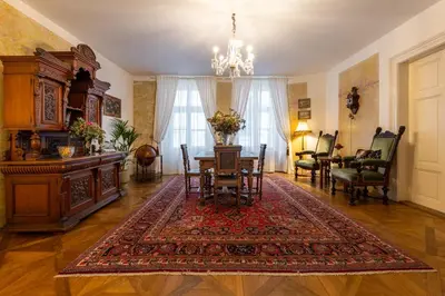 a living room with a table and a dining room at King's Royal Apartments in City Centre in Prague