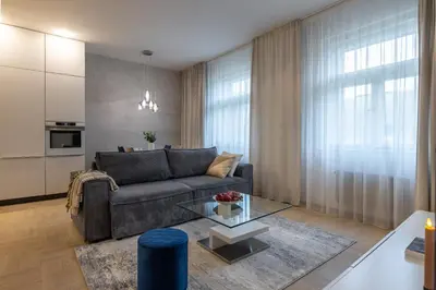a living room with a couch and a table at Chic & Central New Town Apartment by Subway in Prague