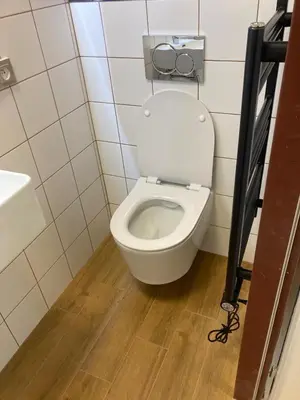 a bathroom with a white toilet in a stall at Tenis Cibulka Suites in Prague