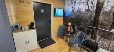 a room with a door and a table and chairs at Tenis Cibulka Suites in Prague