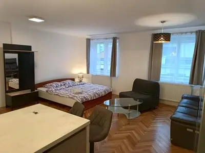 a small room with a bed and a chair and a table at Apartment in the Center of OId Town in Prague