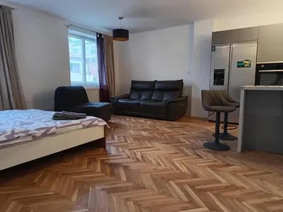 a bedroom with a bed and a couch and a chair at Apartment in the Center of OId Town in Prague