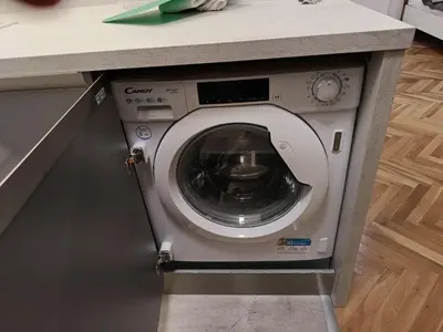 a washing machine in a kitchen under a counter at Apartment in the Center of OId Town in Prague