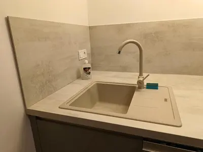 a kitchen sink with a faucet on a counter at Apartment in the Center of OId Town in Prague