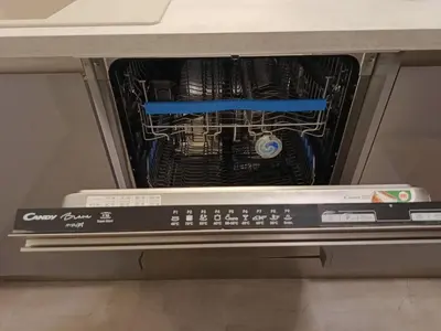 an open dishwasher with a dvd player in it at Apartment in the Center of OId Town in Prague