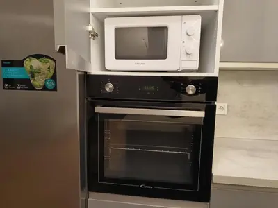 a microwave above an oven with a microwave above it at Apartment in the Center of OId Town in Prague