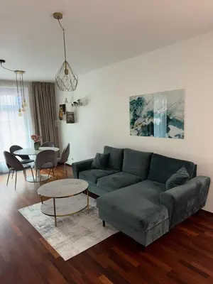 a living room with a couch and a table at Apartmán Palma - 15 min od centra Prahy in Prague