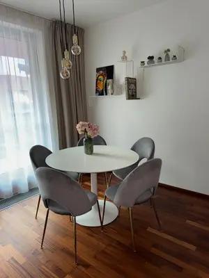 a dining room with a white table and chairs at Apartmán Palma - 15 min od centra Prahy in Prague