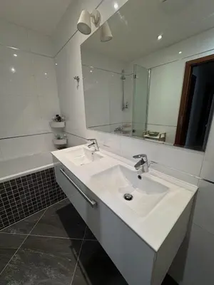 a white bathroom with a sink and a mirror at Apartmán Palma - 15 min od centra Prahy in Prague