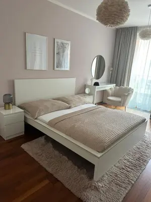 a bedroom with a large bed and a chair at Apartmán Palma - 15 min od centra Prahy in Prague