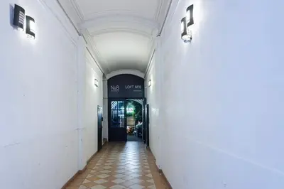 a hallway leading to a building with a door at The Wenceslas Loft in Prague