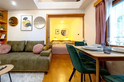 a living room with a couch and a table at The Wenceslas Loft in Prague